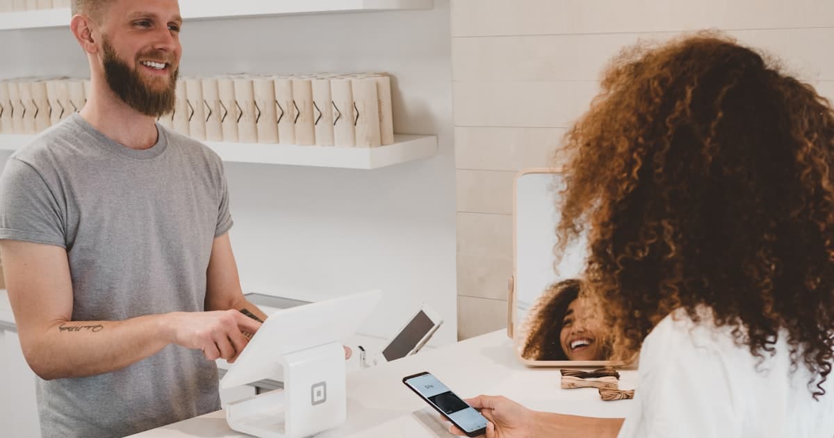 Person cutting a credit card with scissors next to a financial plan
