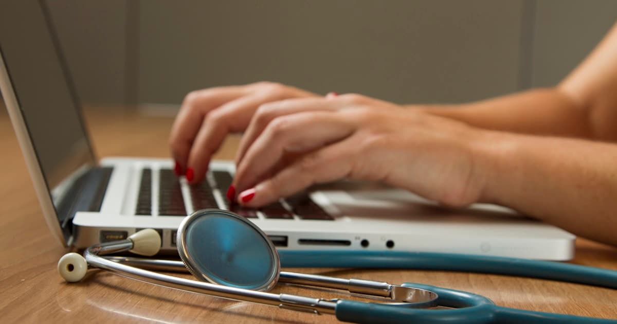 Medical stethoscope next to a piggy bank representing health savings
