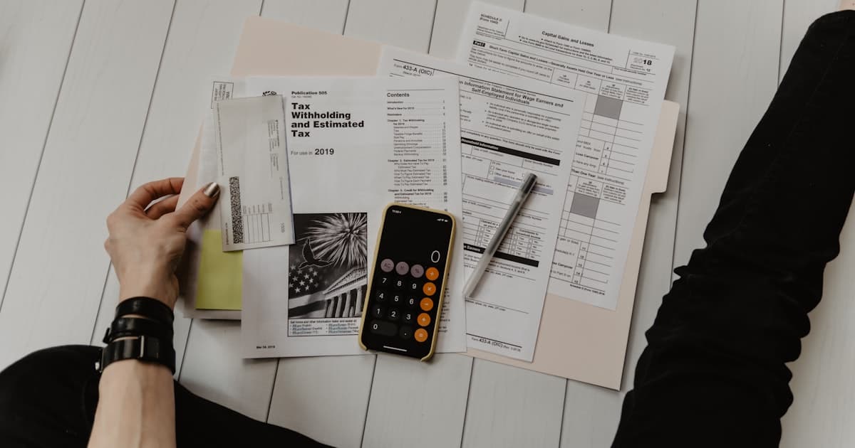 Calculator and financial statements showing income and debt figures